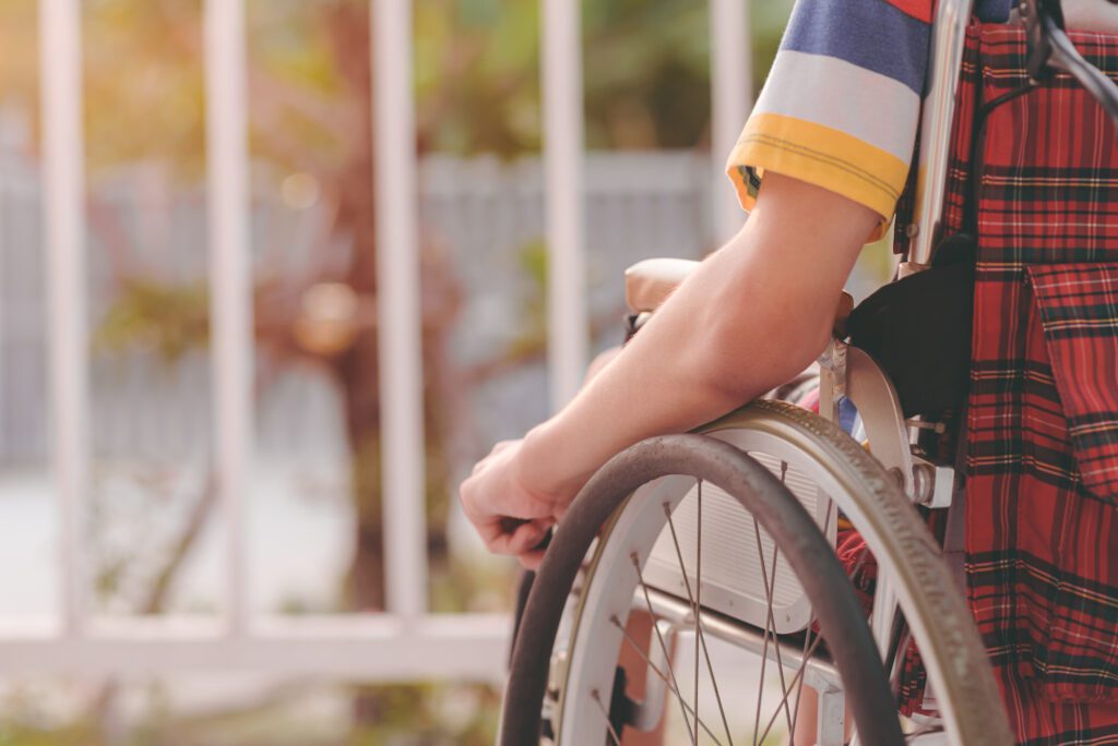 Arm of young man with disability sitting look at the sun on nature background on balcony of home or hospital,school,nursery with sunlight at sunset Positive photography and Good mental health concept.